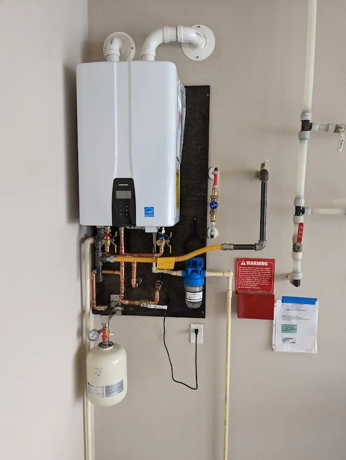 Professional plumber installing copper piping in a Fawn home